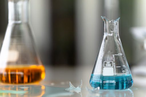 A broken glass beaker in a laboratory.